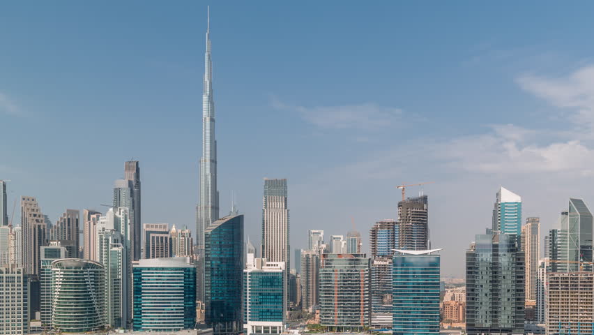 Aerial view to Dubai Business Bay and Downtown with the various skyscrapers and towers along waterfront on canal timelapse. Construction site with cranes. Clouds on a sky Royalty-Free Stock Footage #1110518789