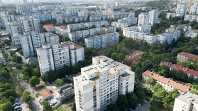 Aerial drone flyover footage of communist era buildings in Eastern Europe. High angle tracking shot of blocks in Sofia Bulgaria. 4k video capturing boring residential buildings from communist times.