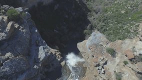 Nature, waterfall and drone in mountain with nature, landscape and top view of water. Rocky cliff, stream and river in Colorado with geology, rock terrain and grass from above outdoor with plants