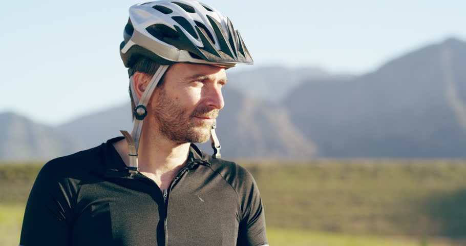 Face, thumbs up and a man cycling in the mountains for fitness, health or wellness during summer. Portrait, smile and bike with a happy athlete outdoor for success, support or exercise motivation