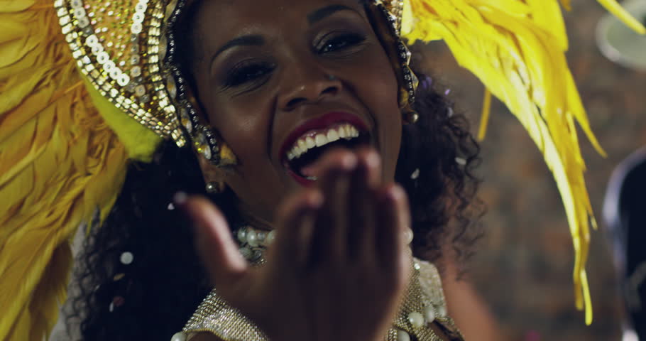 Dance, culture and woman at a traditional parade, party or street mardi gras in Brazil. Celebration, festival and happy female dancer blowing a kiss while dancing in costume at a carnival performance