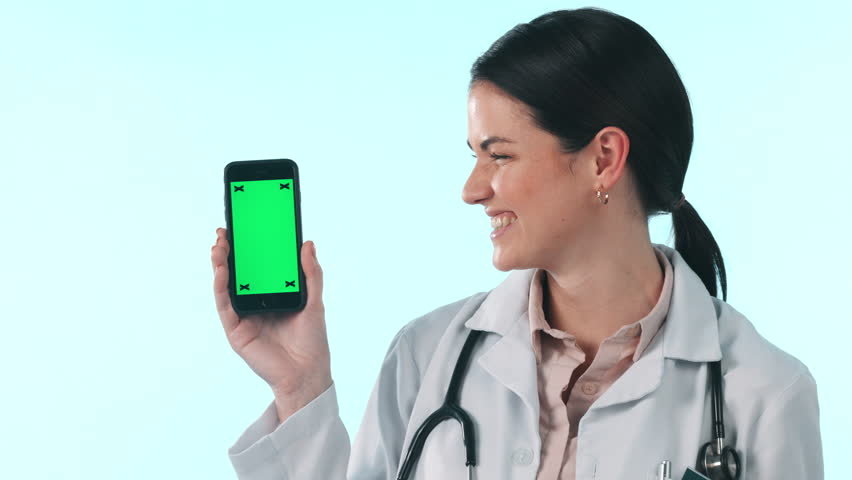 Green screen phone, happy woman and doctor ok, pointing and show online healthcare promo, mockup space or info. Cellphone tracking markers, clinic portrait and surgeon okay vote on studio background