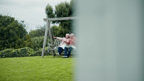 Senior couple on swing in garden with love, conversation and bonding with trees, grass and care. Relax, old man and woman in backyard, talking and drinking coffee with happy marriage in retirement. - Powered by Shutterstock - Get 15% off with code: PIKWIZARD15