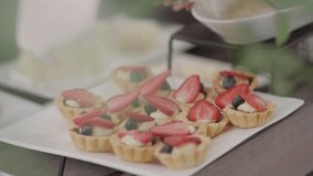 Delicious fruit tartlets with a golden crust, topped with fresh, glistening strawberries and blueberries