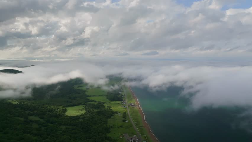 Break in coastal clouds and fog over Northern Hokkaido road in summer