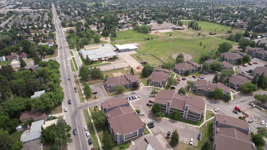 Aerial video of Forest Grove, Saskatoon, SK, capturing its leafy streets, residential homes, and community vibe. A verdant urban pocket showcasing harmonious living. Perfect for city landscapes.