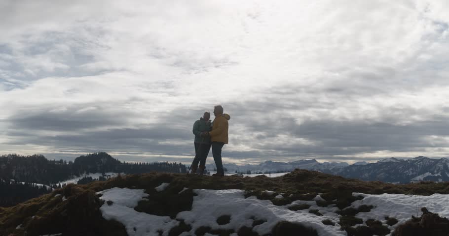 Elderly couple having tender moment at mountain peak during winter time - Active senior people, travel and love concept Royalty-Free Stock Footage #1110551767
