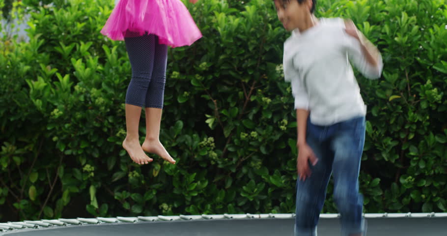 Jump, fun and children on a trampoline in the garden of their home together for sibling bonding. Family, brother and sister in the backyard to bounce while playing as kids during summer break