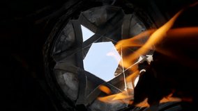 Vertical video of the Jewish Star of David and fire in slow motion. Israel's symbol on fire symbolizes the war with Palestine. Flame and six-pointed Jewish star in the dome of the temple. Near East
