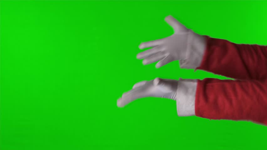 Santa's hand shows something with a green screen background			 Royalty-Free Stock Footage #1110561847