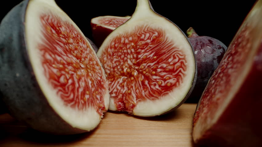 Sliced Figs, ripe and red inside. Macro zoom. Dolly slider extreme close-up.