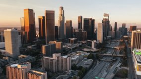Aerial View Shot of Los Angeles LA CA, L.A. California USA, day daytime, downtown LA, DTLA, LA Skyline, wide close, circling right, golden light