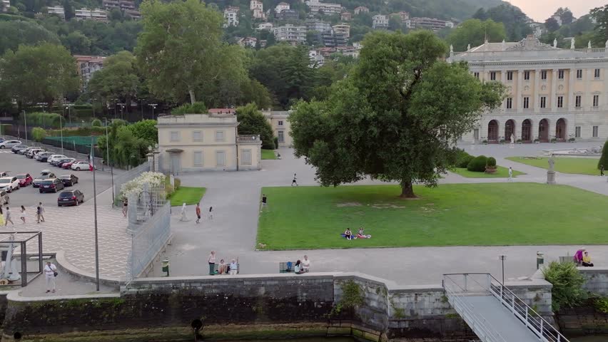 An aerial view of visitors walking near the Villa Olmo building in Como, Italy