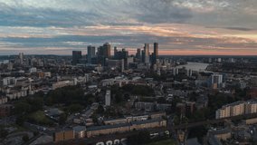 Establishing Aerial View Shot of London UK, United Kingdom, day, Canary Wharf, Business District, East London, Isle of Dogs, super sky, track back reveal