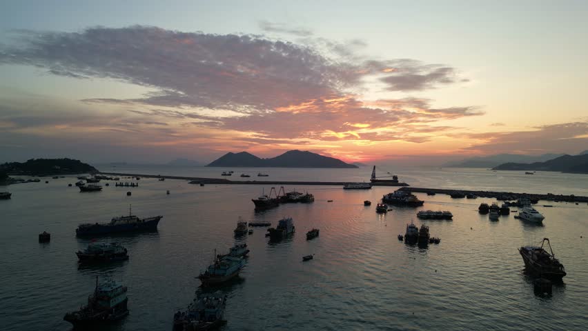 Cheung Chau, Hong Kong: Aerial drone footage of a dramatic sunset over the Cheung Chau island, famous for its fisherman harbor and relaxing traditional town in Hongkong. 