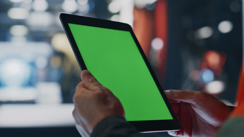 Engineer hands working on green screen tablet at factory workshop closeup. Unknown technical specialist holding mockup pad computer on manufacturing. Uniformed technician scrolling chroma key touchpad Royalty-Free Stock Footage #1110576991
