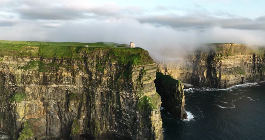 Cliffs of Moher shrouded in low clouds on a sunset 4k Royalty-Free Stock Footage #1110578421