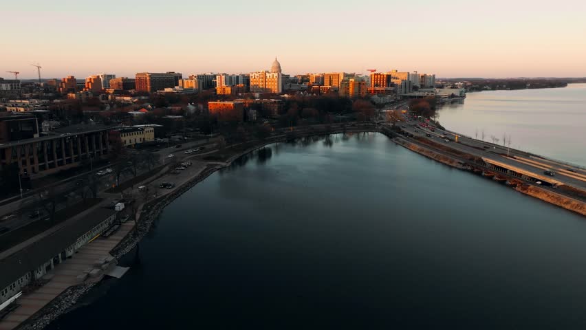 A drone footage over The Wisconsin river alongside the city of Sauk City, Wisconsin at sunset