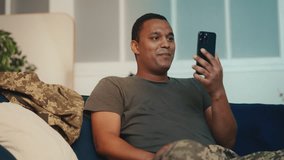 Military man talking family via mobile application on smartphone, communication