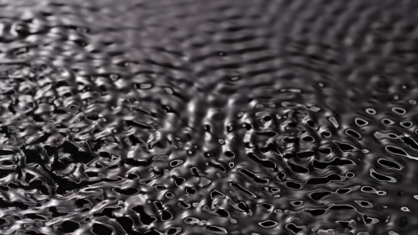 Black water surface monochrome, moving circles and ripples under ultra sound vibrations, abstract background template.