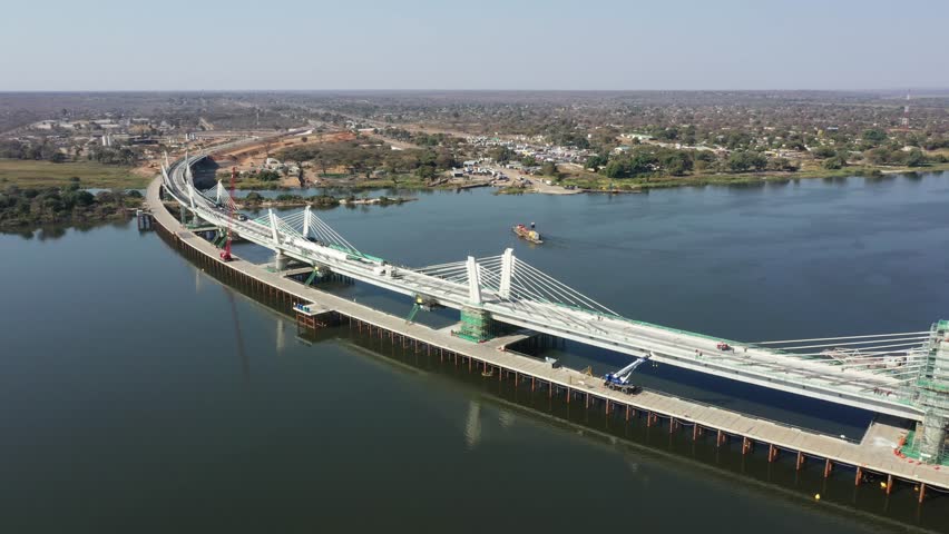 Aerial view of the construction phase of the Kazungula bridge over the Chobe river near Kasane, Botswana, Africa Royalty-Free Stock Footage #1110585349