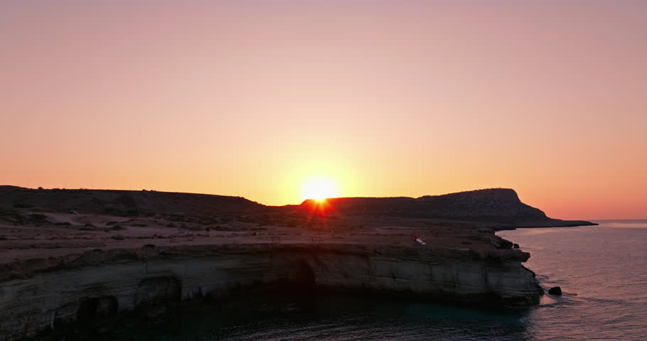 Aerial view of the natural landscape of rocks and the sea on the island of Cyprus. Beautiful sunset over the Mediterranean Sea. High quality 4k footage