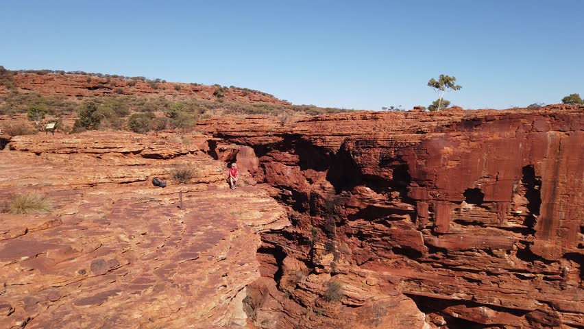 Carefree woman enjoying panoramic views of Kings Canyon in Watarrka National Park, Australia
