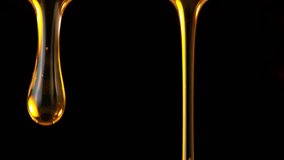 Super Slow Motion Shot of Falling Golden Oil Droplets Isolated on Black Background at 1000 fps. - Powered by Shutterstock - Get 15% off with code: PIKWIZARD15