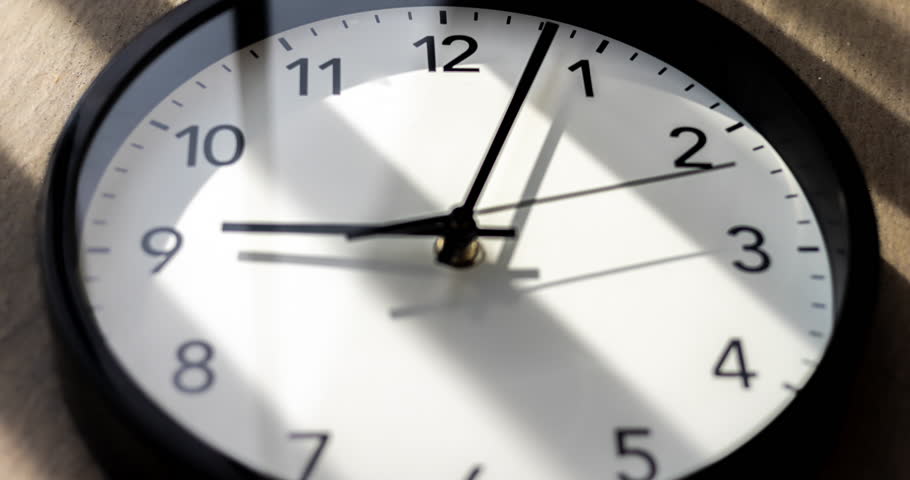 Wall clock show the running time. Time lapse on a modern wall clock.  Close up to a wall clock, with running time pointer. Sun and sky reflecting in the watch during the time passing by | Shutterstock HD Video #1110591553