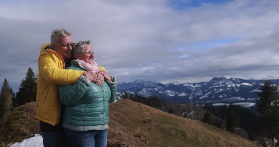 Senior couple having tender moment at mountain peak during winter hiking day Royalty-Free Stock Footage #1110592333