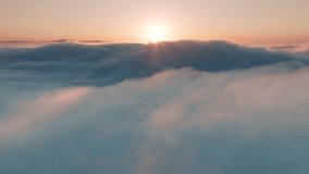Aerial view above beautiful ocean of clouds at golden sunrise. Amazing sky nature landscape, 4K drone. Sun rising above endless sea of clouds until horizon. Drone raising above pastel pink thick fog - Powered by Shutterstock - Get 15% off with code: PIKWIZARD15