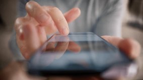 Browsing movie video on internet library to watch film online. Slow motion male fingers touching modern smartphone screen 4K. Cinematic close up man scrolling pages in mobile app on cell phone device - Powered by Shutterstock - Get 15% off with code: PIKWIZARD15