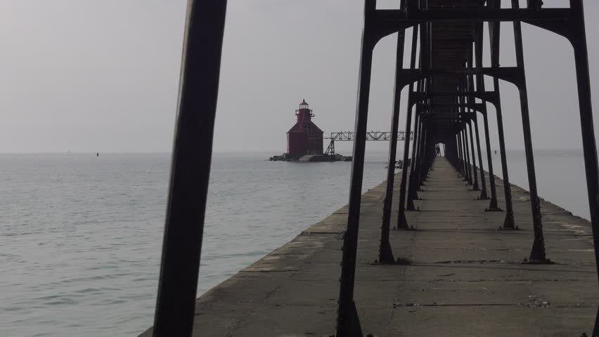 Sturgeon Bay lighthouse on Lake Michigan. Wide static shot through the catwalk uprights. Shot on a bleak, very overcast day as Canadian wildfire smoke moves in.