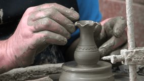 Video of skilled potter’s hands creating the clay bowl on the potter's wheel at the local workshop. Crete