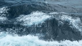 Beautiful waves from moving boat. Clip. Splashes of waves from moving sea boat. Beautiful waves moving sideways from floating boat in sea