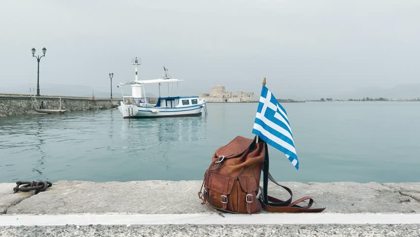 Travel, vacation or tour tourism in Greece concept- Bag and Greek flag in Nafplio city- Peloponnese