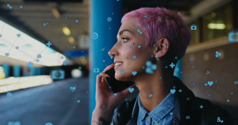 Animation of connected icons, biracial woman talking on cellphone while waiting for train at station. Digital composite, multiple exposure, communication, transportation and technology concept.
