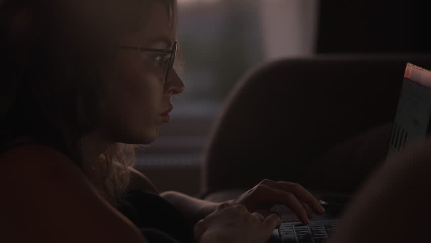 Tired woman work laptop home. Serious pretty girl typing computer pc keyboard close up. Young adult student wear glasses. Freelance overtime job. Person write web email late night. Dark evening light. | Shutterstock HD Video #1110604929