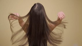 Luxurious long brunette hair. Back view. Yellow background. - Powered by Shutterstock - Get 15% off with code: PIKWIZARD15