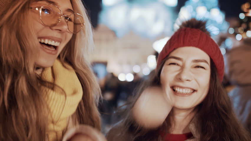 Multiracial group of friends having fun with sparklers outdoor celebrating merry Christmas xmas and happy new year. Two women portrait smiling waving firework express joy happiness. Christmas holiday Royalty-Free Stock Footage #1110611823