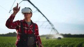 Agriculture.Farmer wearing virtual reality glasses in cornfield. Automatic watering system for plants in drought. Farmer irrigates green fields with help of modern technologies. Farm irrigation system - Powered by Shutterstock - Get 15% off with code: PIKWIZARD15
