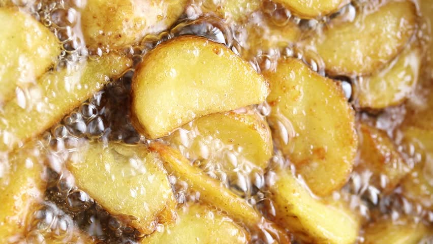 Crispy potato wedges are fried in boiling oil. Top view Royalty-Free Stock Footage #1110621141