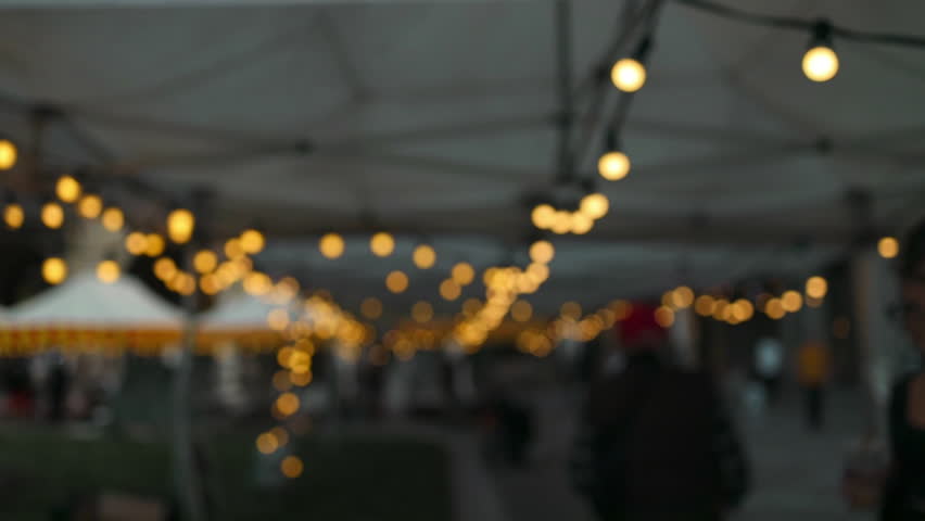 Christmas blurred background, backyard illumination, light in the evening city street, electric lanterns with round diffuser. 