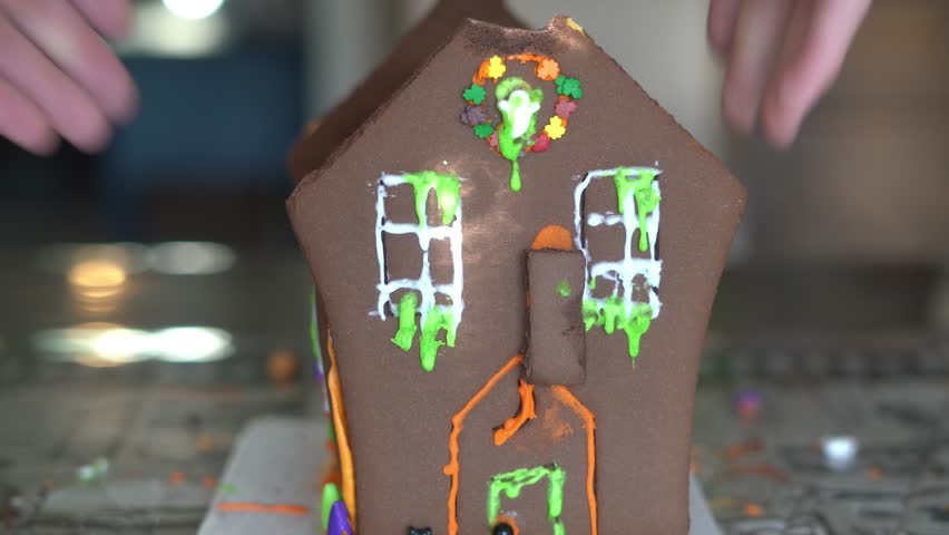 Destroying gingerbread house with hammer, taking apart gingerbread house Royalty-Free Stock Footage #1110626485