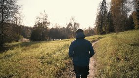 Vegetarian trainer runner in warm sportswear winter weight loss workout in the park.  The athlete is active and healthy in winter in the park. A confident and hardy man. - Powered by Shutterstock - Get 15% off with code: PIKWIZARD15