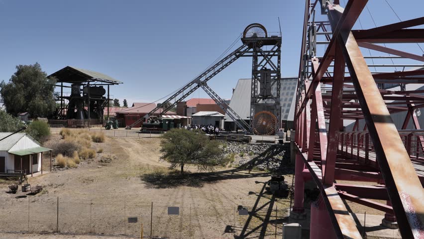 Tourists gather below giant headframe before going into Big Hole mine
