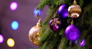 Christmas balls on a fir branch moves across a beautiful background with shining lights, Christmas abstract design for video montage