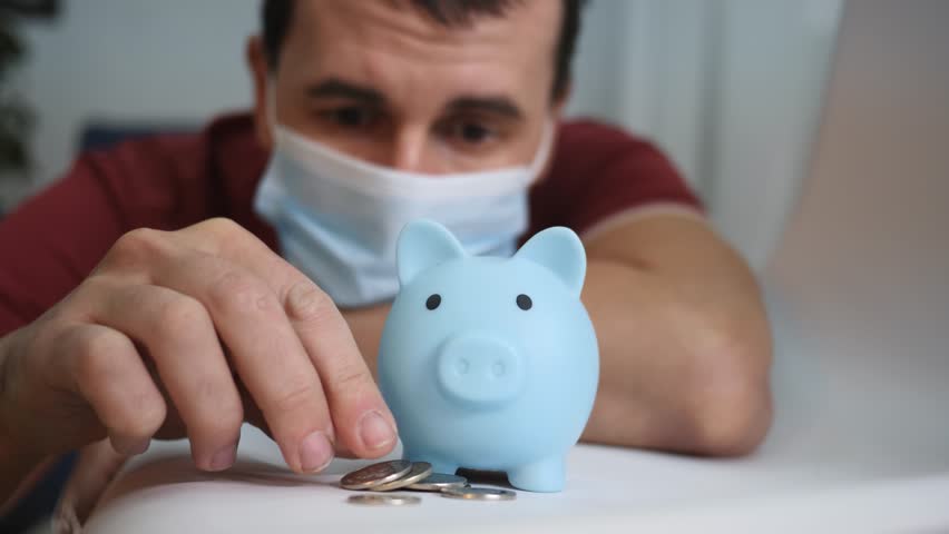 Financial planning concept. man with a piggy bank in self isolation. businessman plans profits and expenses. financial accounting of money in piggy bank. saving money in piggy bank for future project Royalty-Free Stock Footage #1110632569