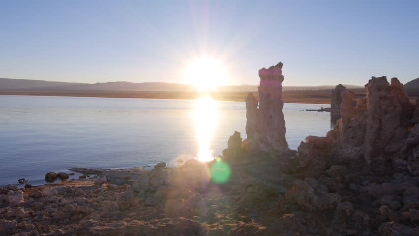 AERIAL: Sunrise sun shining on beautiful tufas in Mono Lake