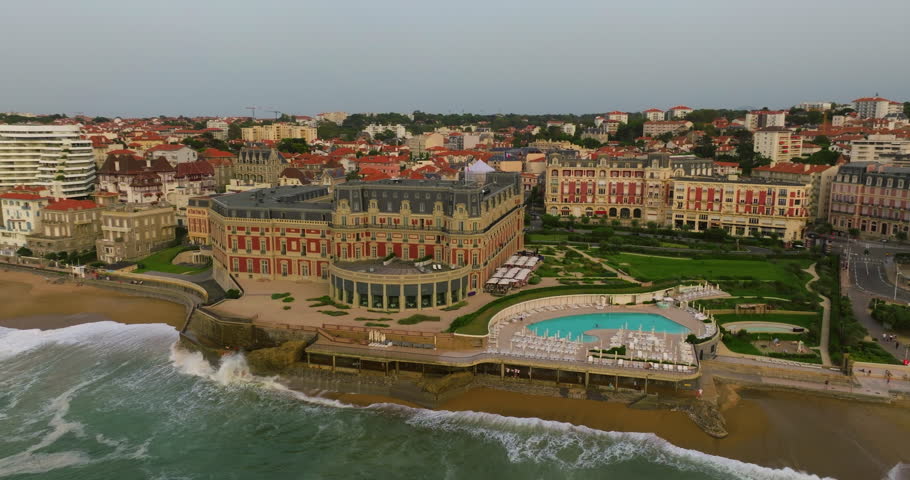 Biarritz large aerial view of the main beach and Biarritz city sunny afternoon France. View of facade of Hotel Sofitel Biarritz Le Miramar Thalassa Sea and Spa on the Miramar beach
